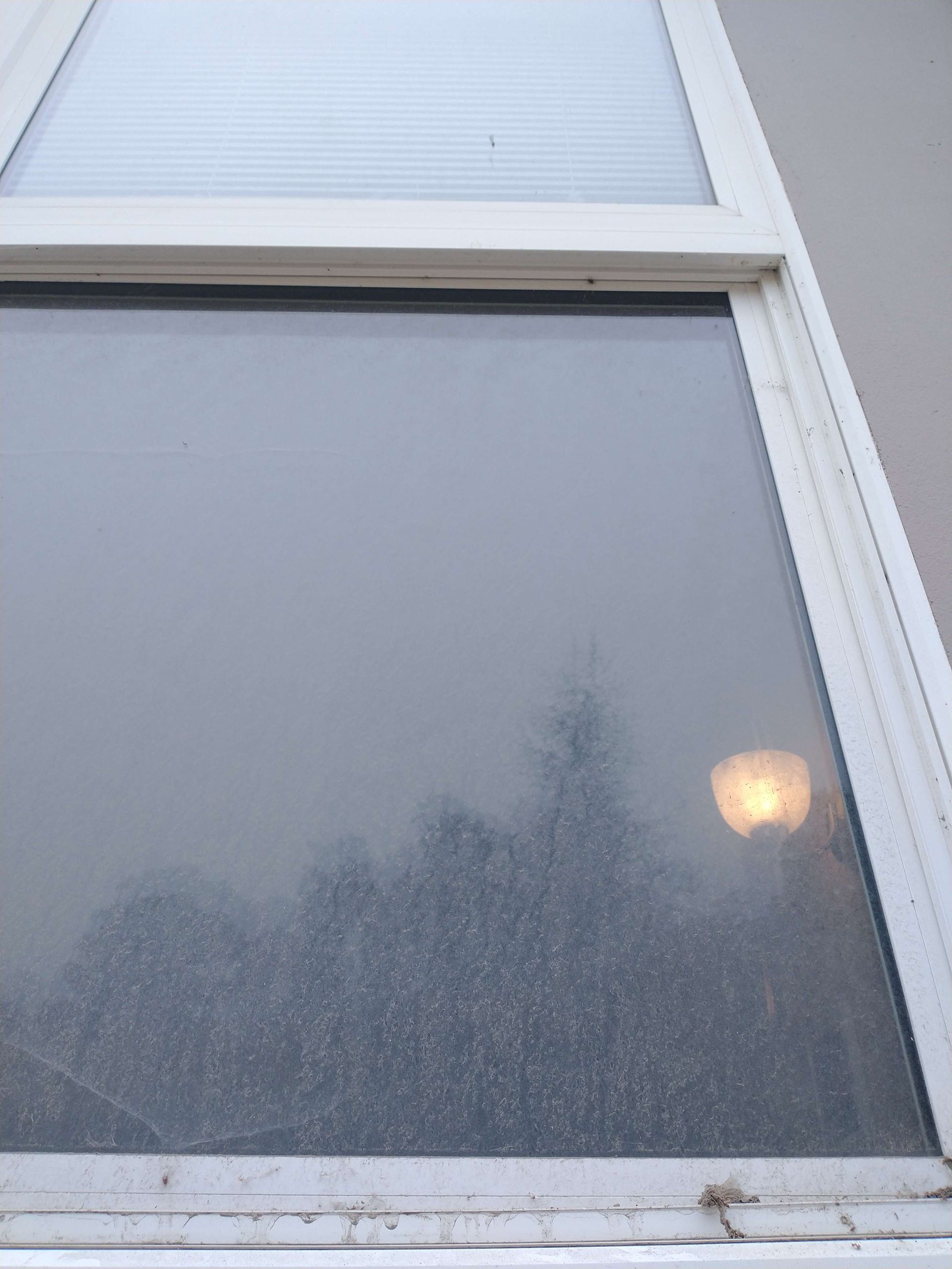 A close up of a window with a light shining through it