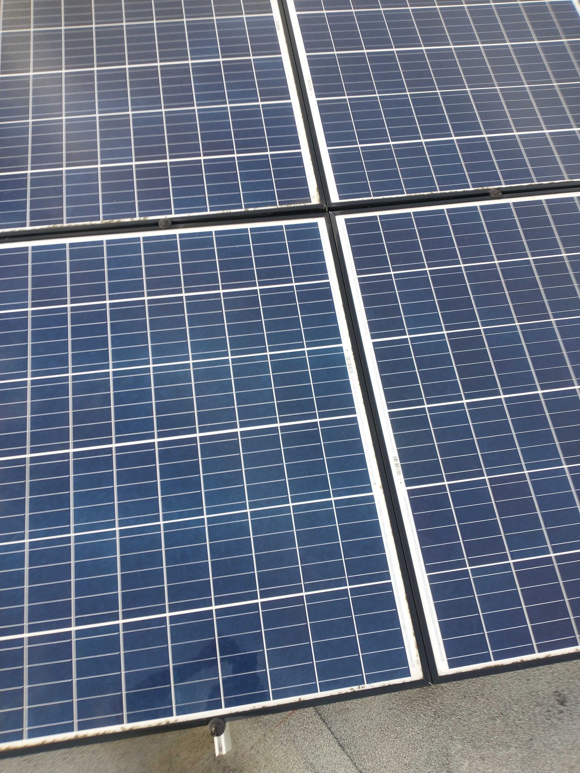 A close up of four solar panels on a roof