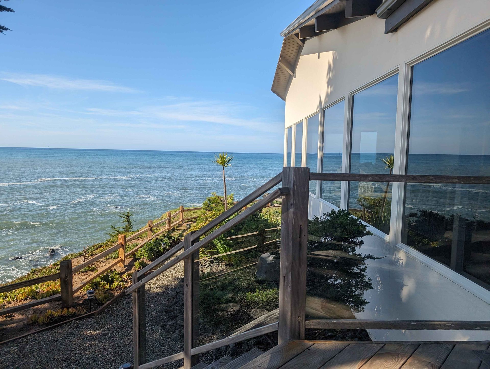 A house with a balcony overlooking the ocean.