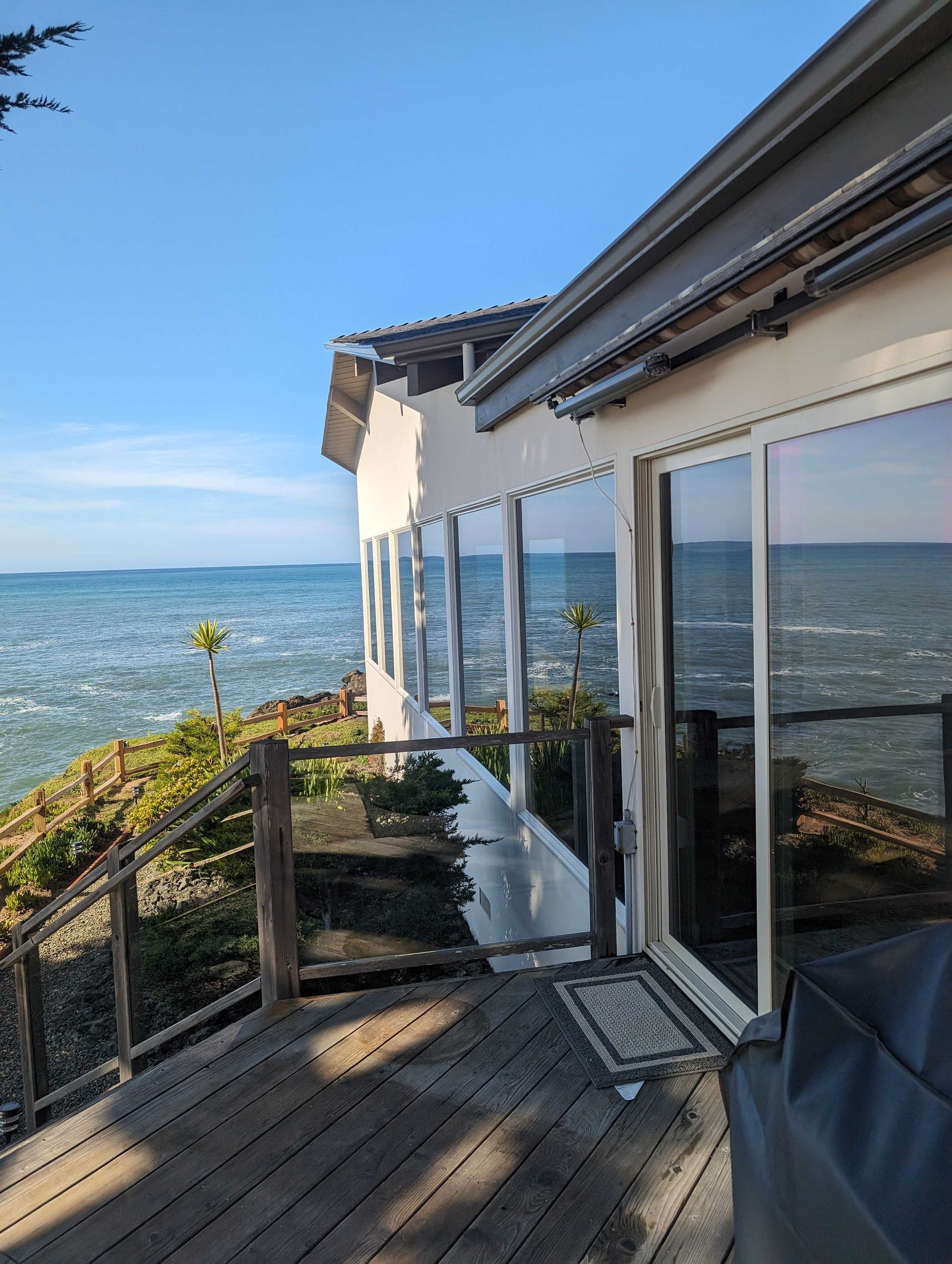 A house with a large deck overlooking the ocean.