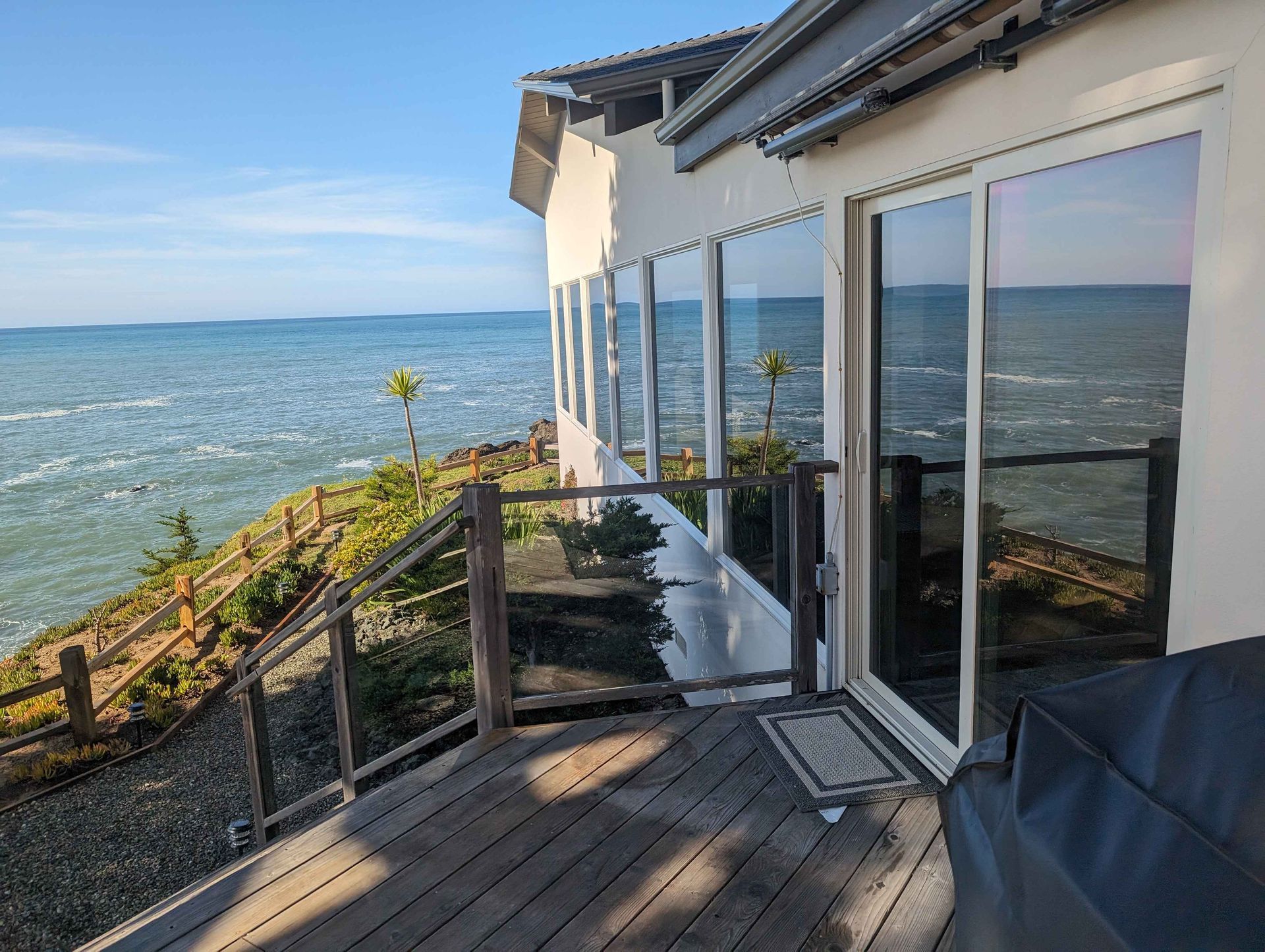 A house with a large deck overlooking the ocean.