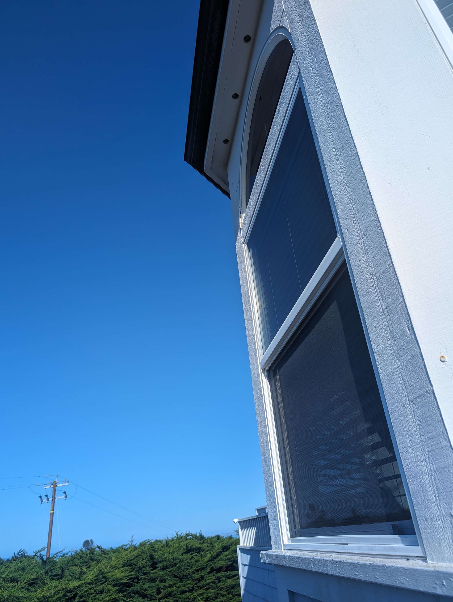 A white building with a blue sky in the background