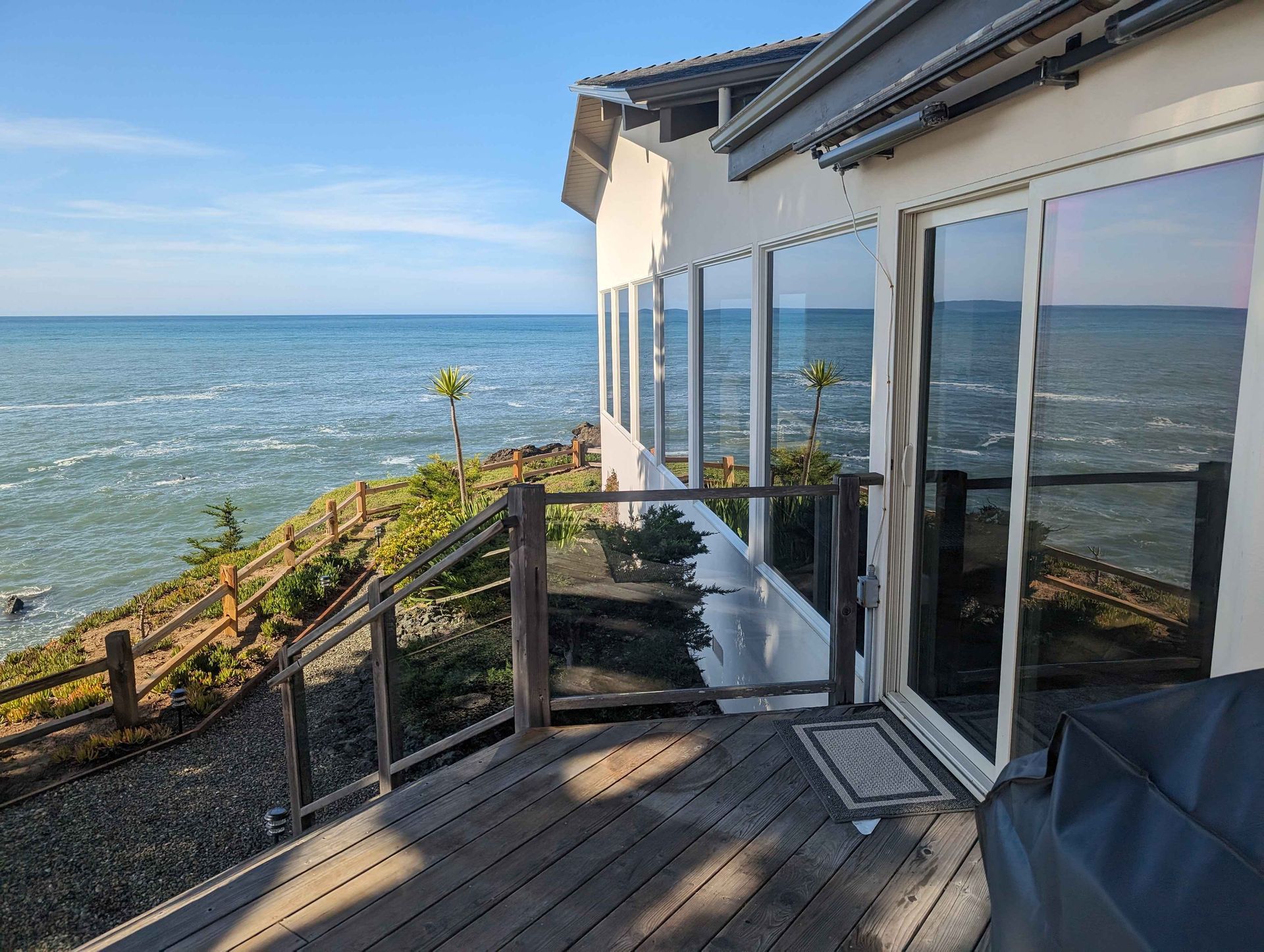 A house with a large deck overlooking the ocean.