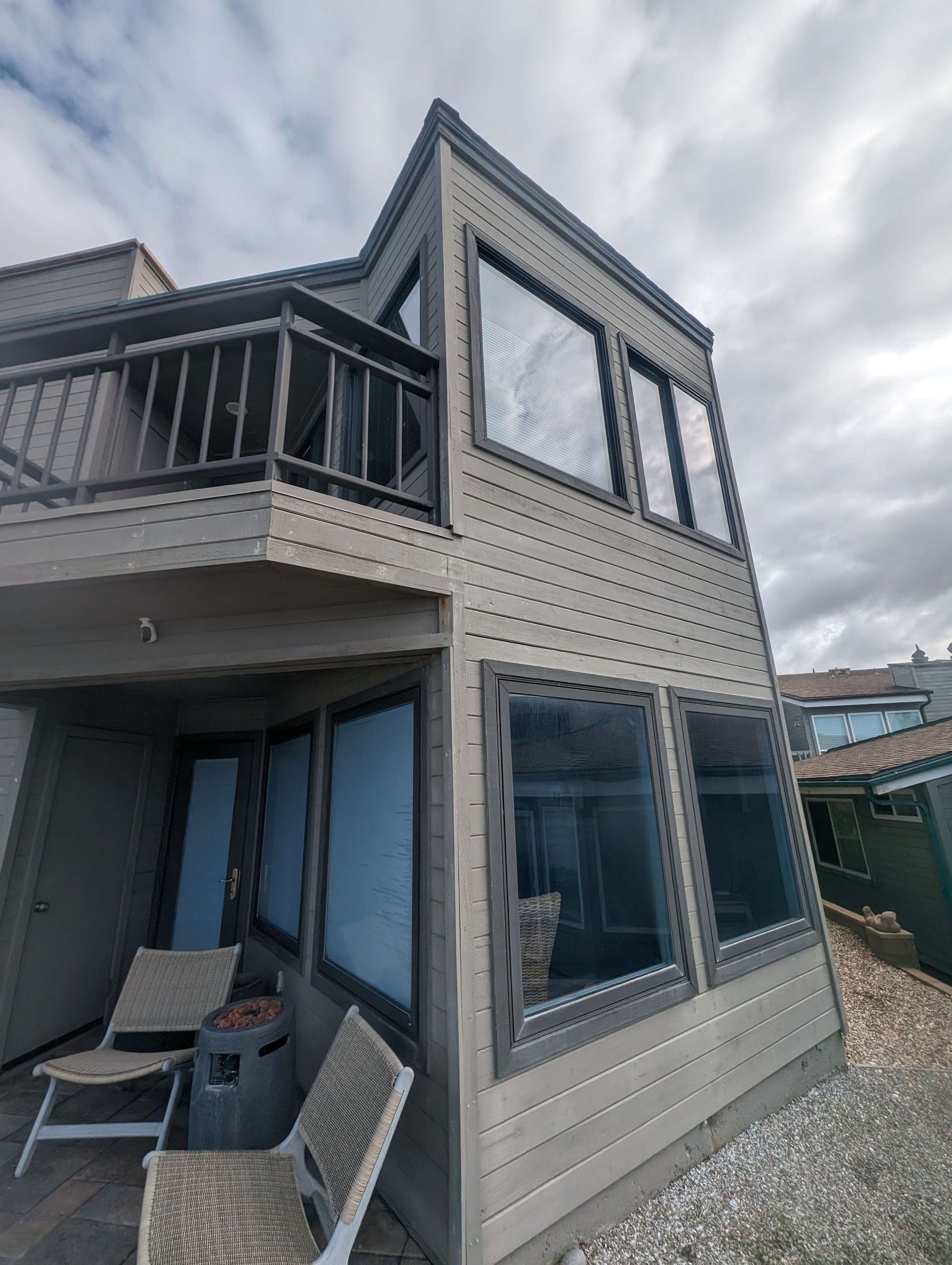 A house with a balcony and a lot of windows.