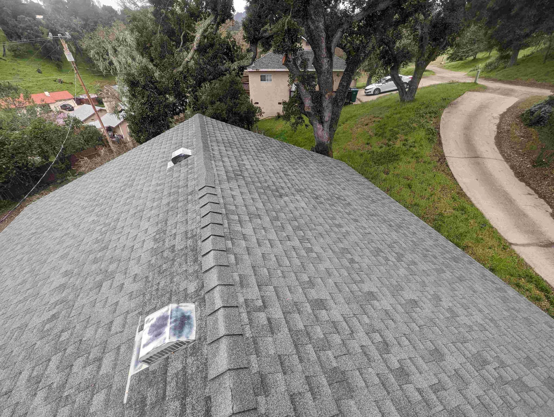 An aerial view of a roof with a solar panel on it.