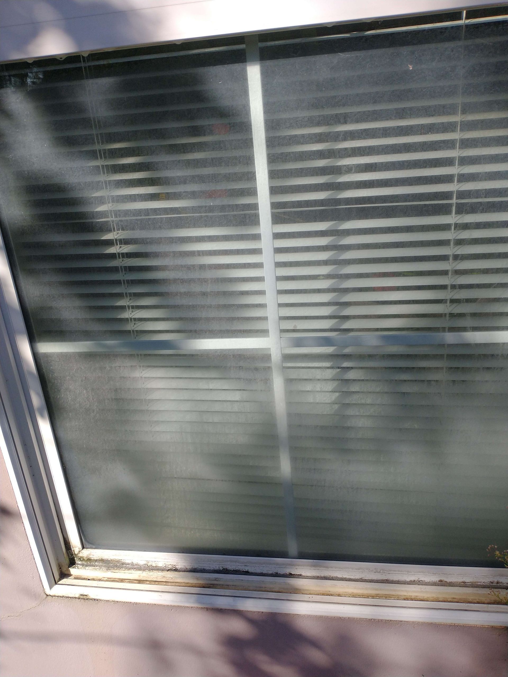 A close up of a window with blinds on it