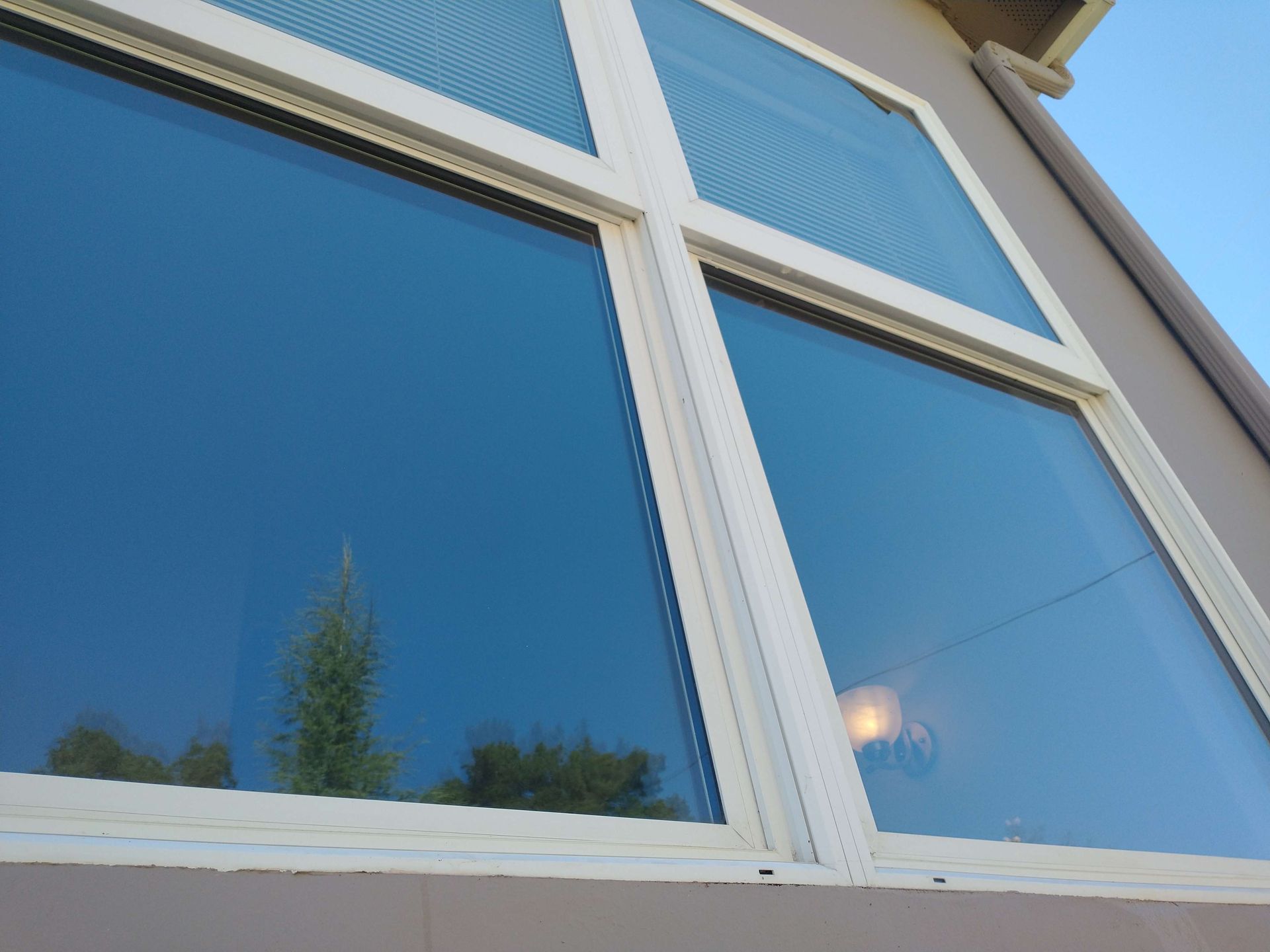 A white window with a blue sky reflected in it