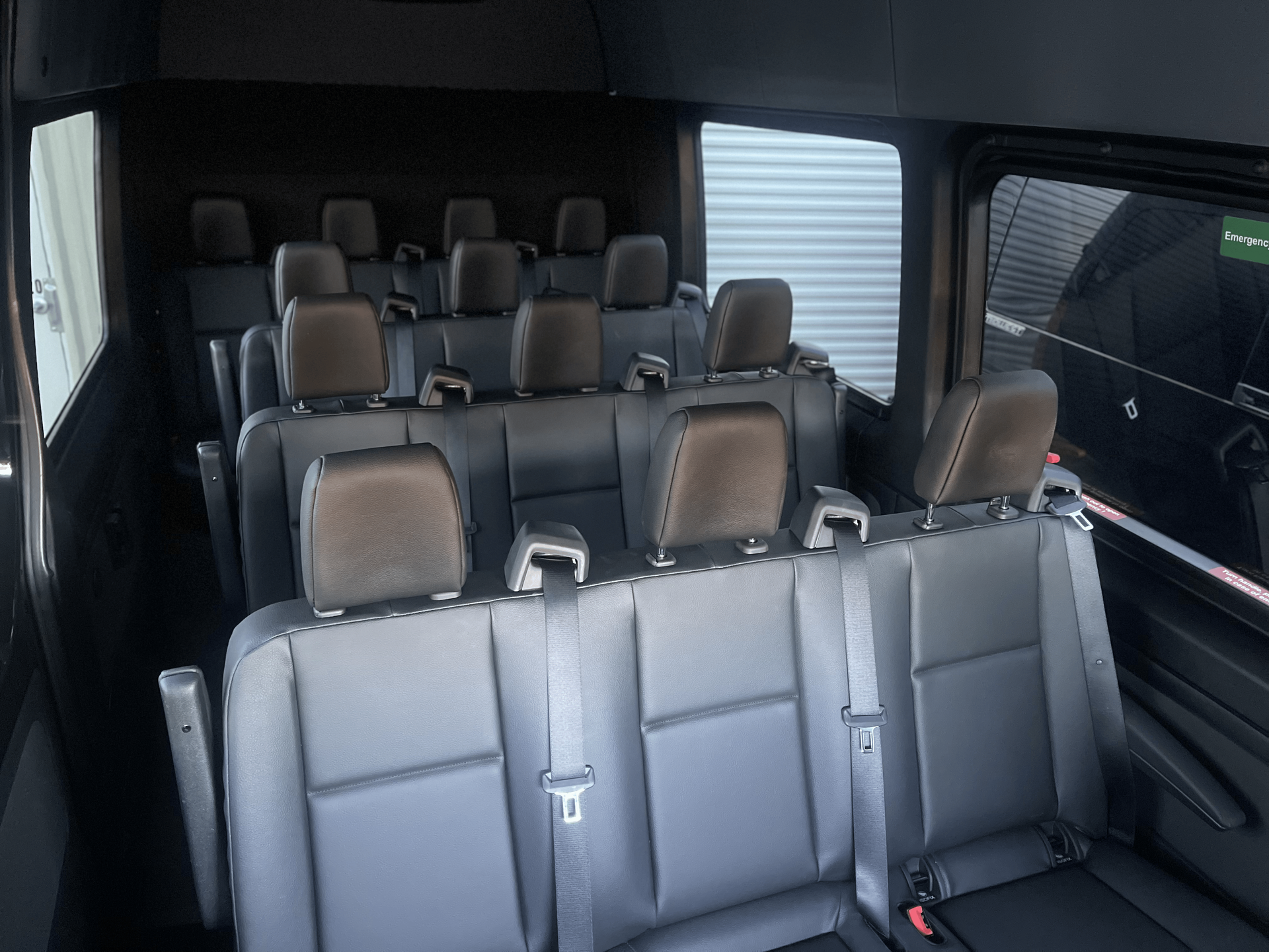 The inside of a van with a lot of seats and a window.