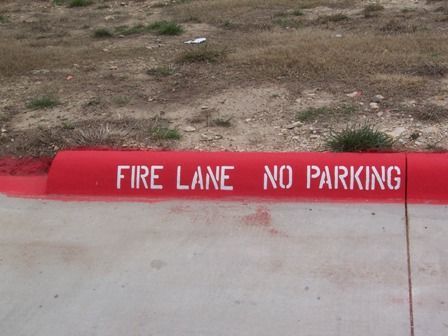 Red curb with white text: 