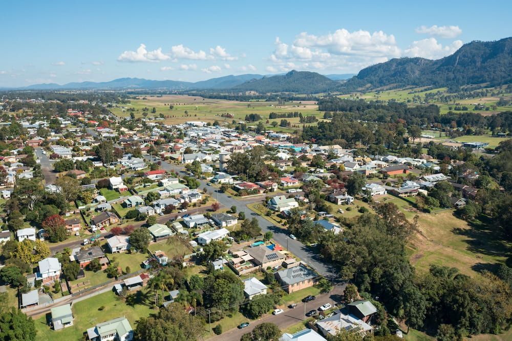 An Aerial View Of A Small Town With Mountains In The Background — Twin Towns Removals Mid North Coast In Gloucester, NSW