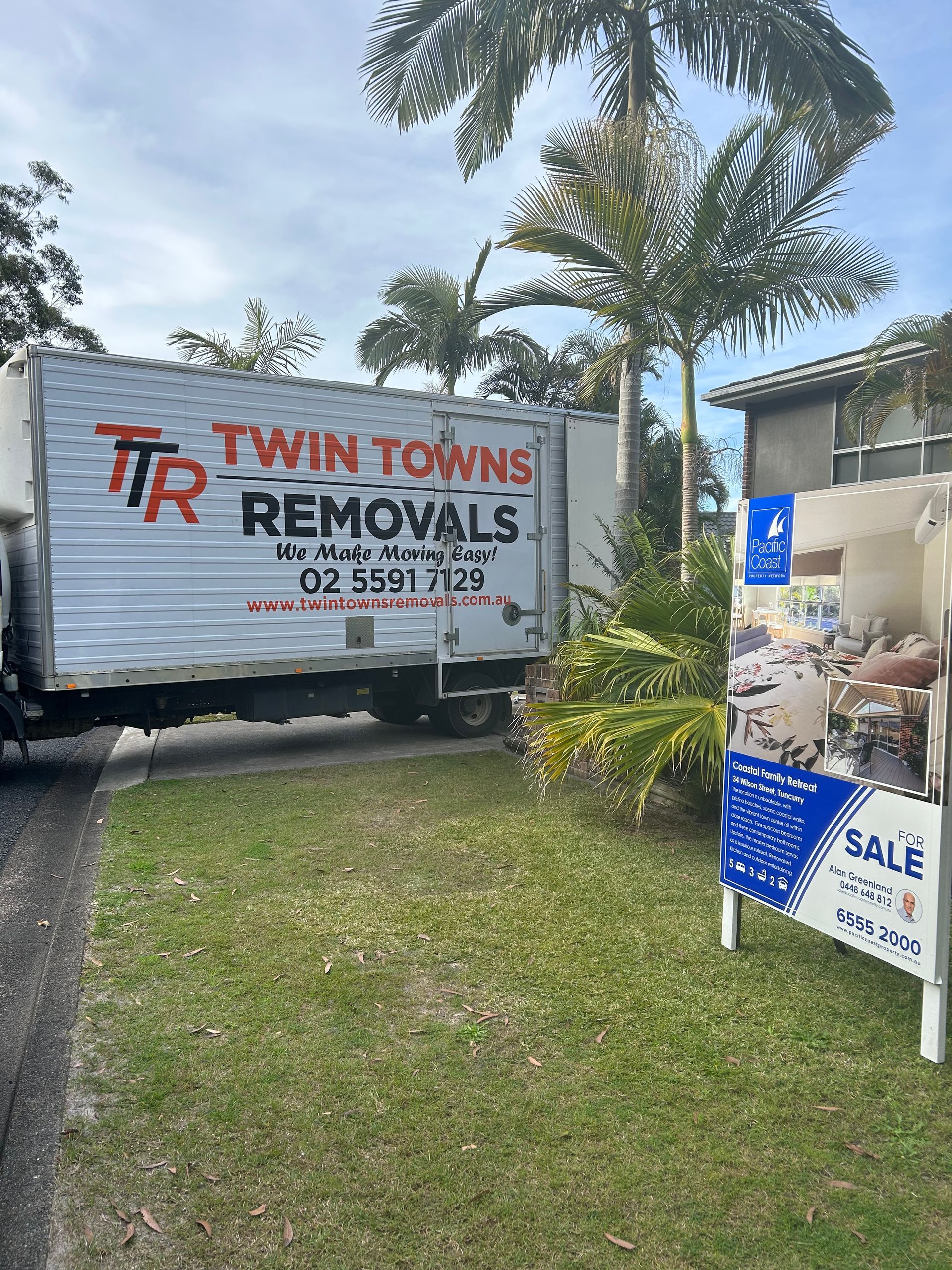 A Moving Truck Is Parked On The Road Side — Twin Towns Removals Mid North Coast In Tuncurry, NSW