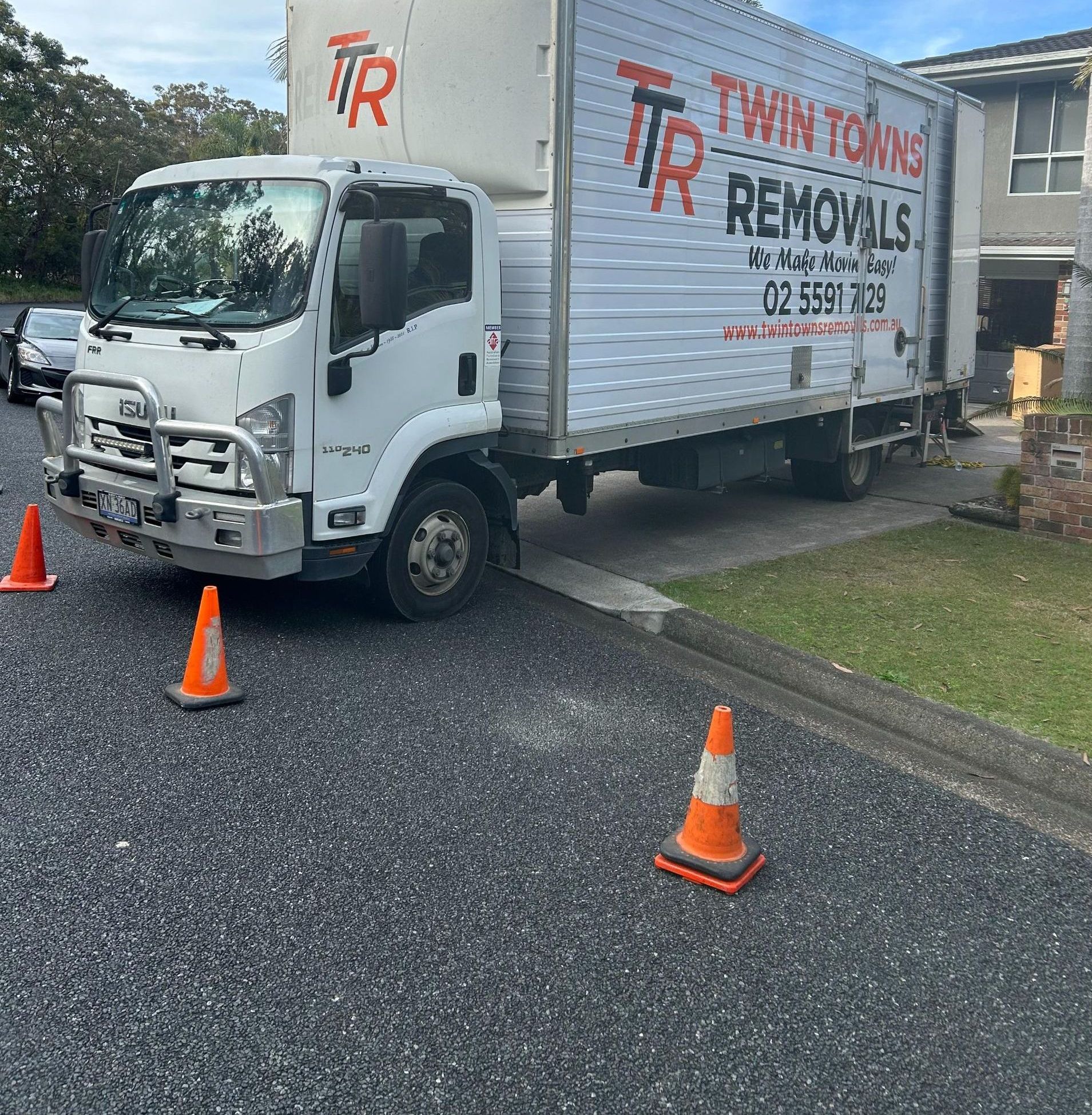 White Removal Truck Parked At House With Traffic Cones Around It — Twin Towns Removals Mid North Coast In Tuncurry, NSW