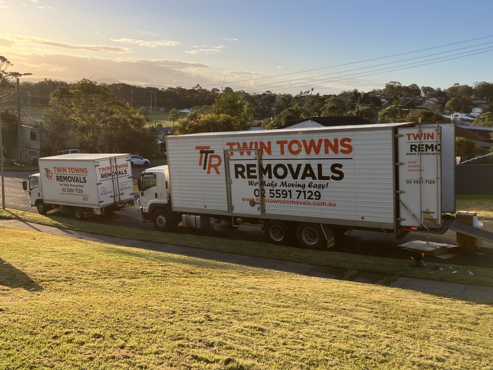 Two White Removal Trucks Parked Next To Grass — Twin Towns Removals Mid North Coast In Tuncurry, NSW