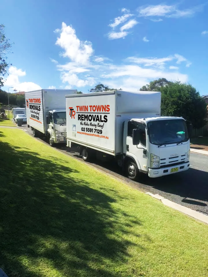 A Row Of Moving Trucks Parked — Twin Towns Removals Mid North Coast In Tuncurry, NSW