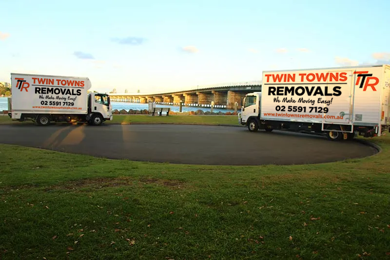 Two Removal Trucks Parked Next To Bridge — Twin Towns Removals Mid North Coast In Tuncurry, NSW