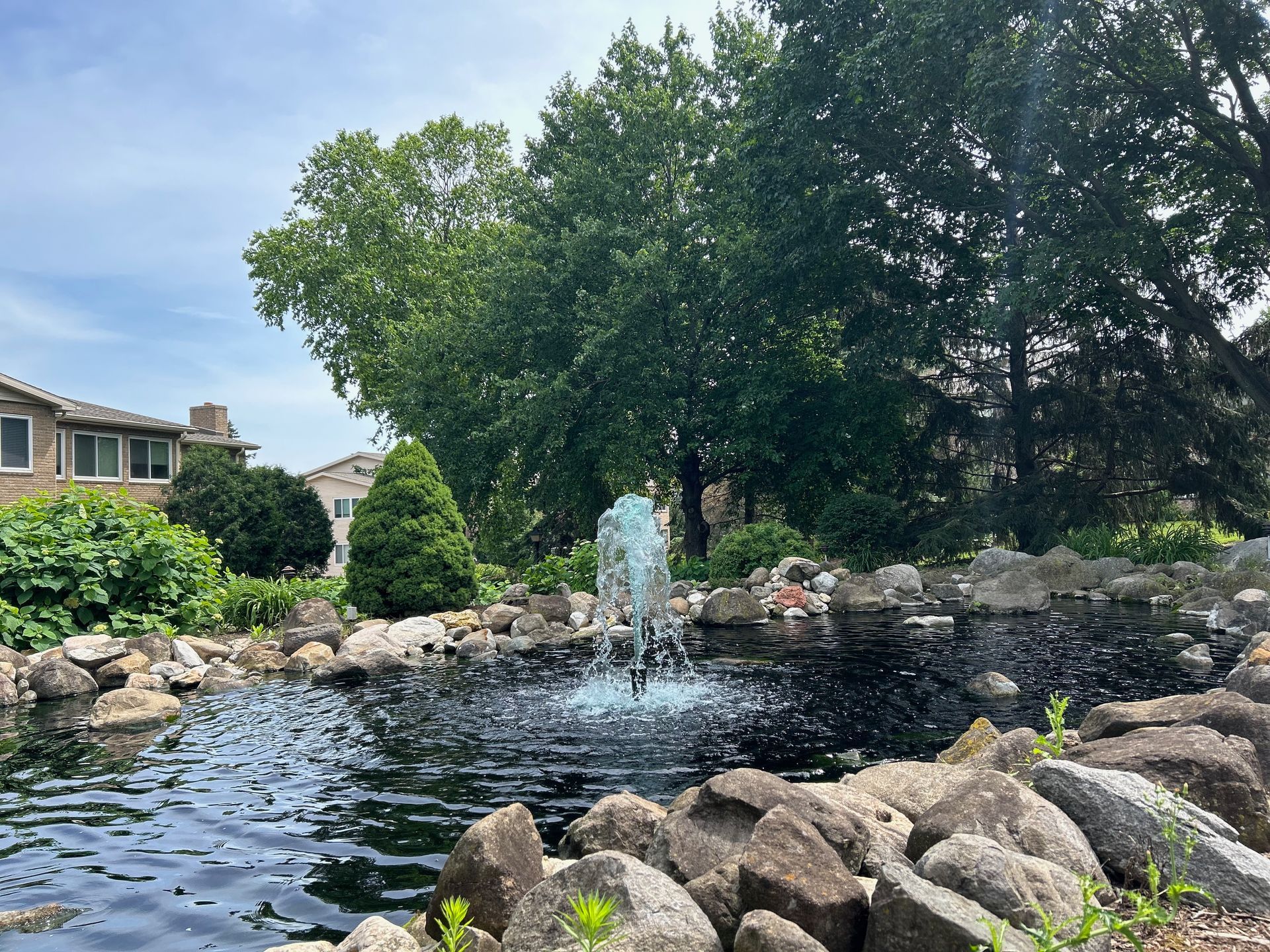 A pond with a fountain in the middle of it