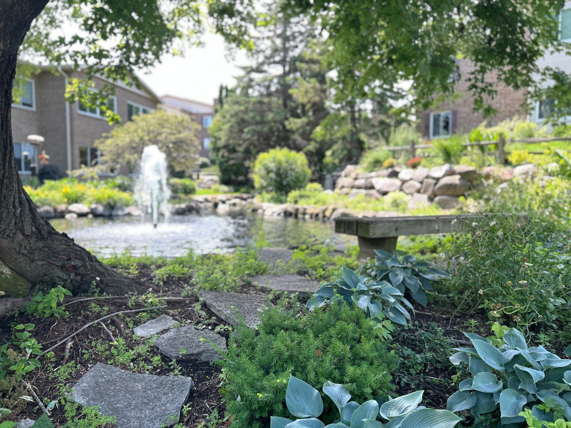 There is a fountain in the middle of the garden.