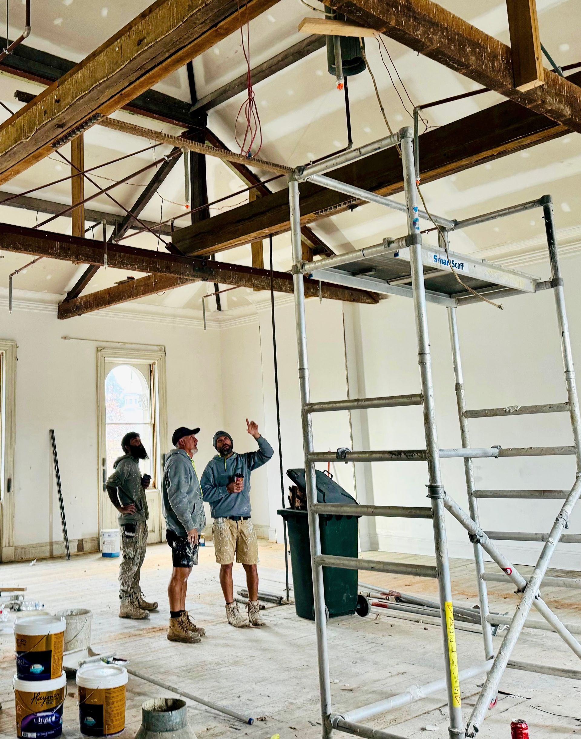 A Fireplace Is Being Painted With A Paint Roller — Crampton Painting & Decorating Pty Ltd In Maiden Gully, VIC