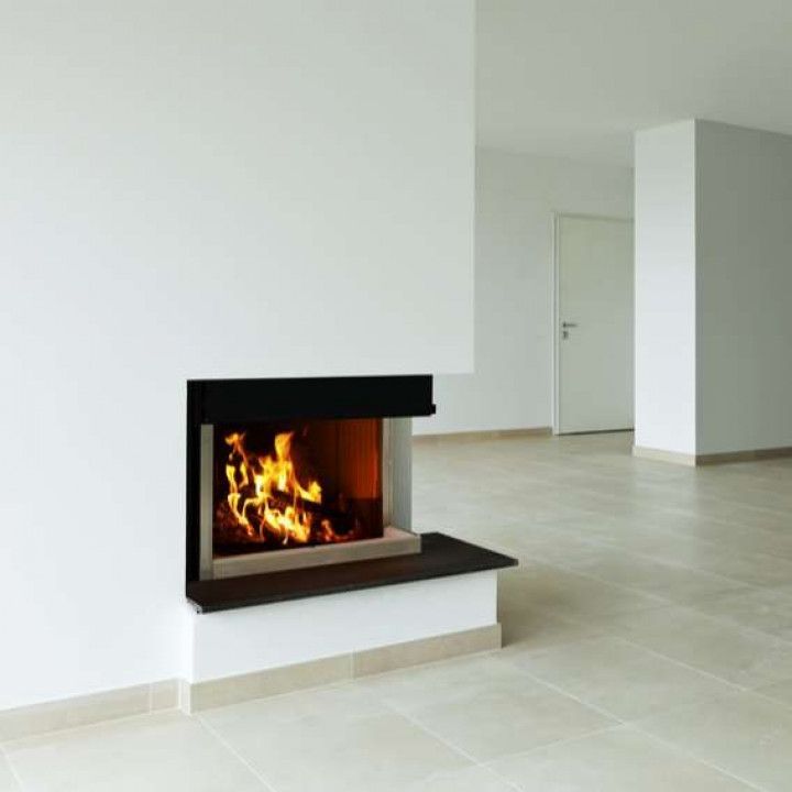 An empty room with a fireplace in the corner