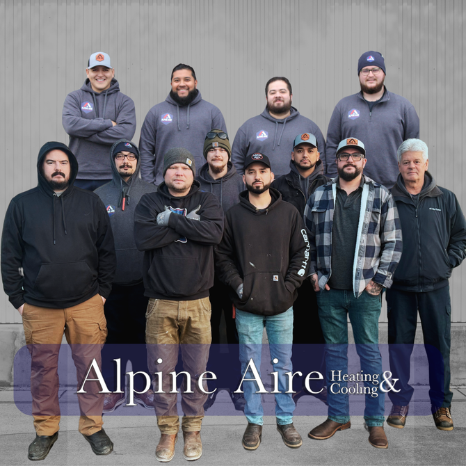 A group of people are posing for a picture in front of a building.