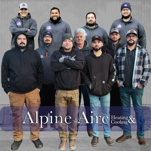 A group of people are posing for a picture in front of a building.