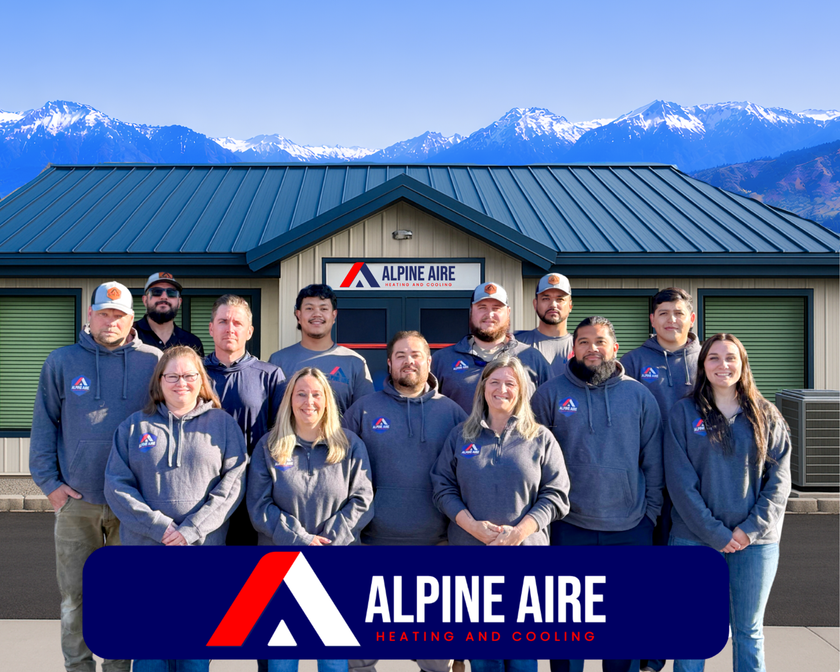A group of people are posing for a picture in front of a building.