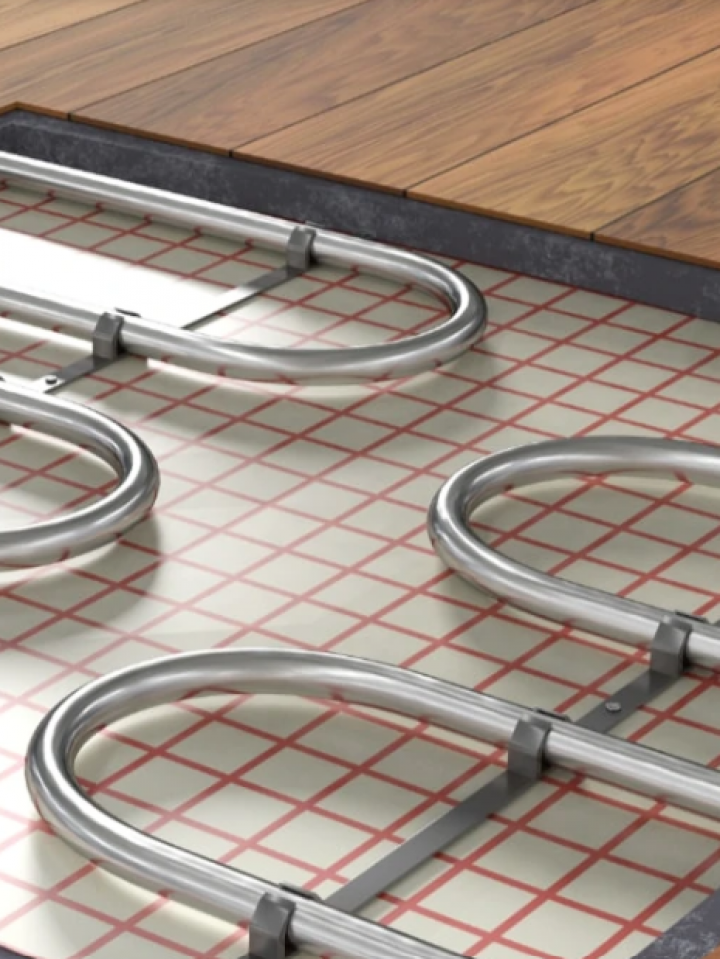 A close up of a underfloor heating system on a wooden floor.