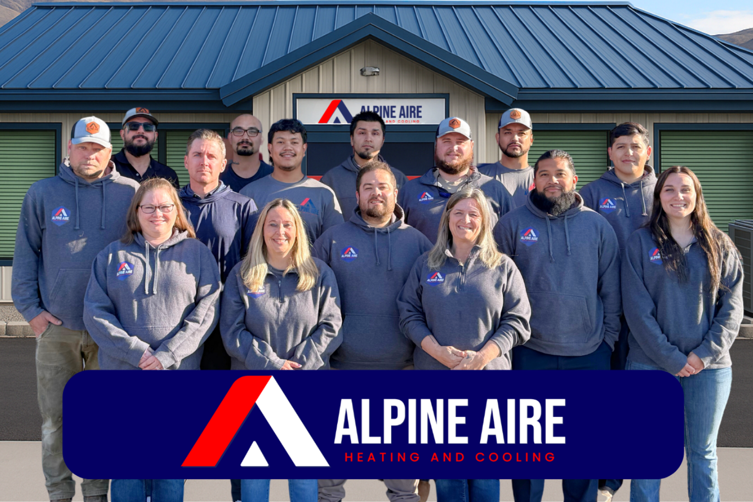 A group of people are posing for a picture in front of a building.