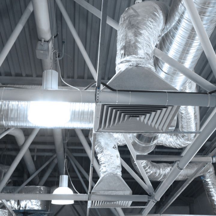 A ceiling with a lot of pipes hanging from it