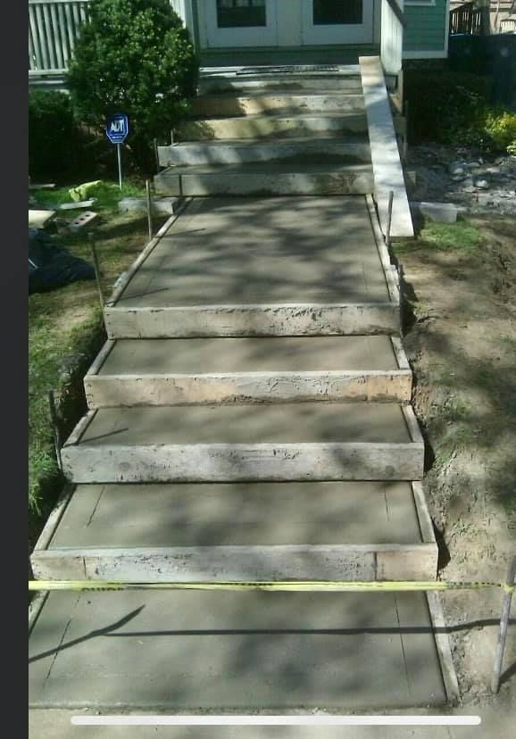 Concrete Staircase Is Being Measured With A Tape Measure — Rochester, NY — Monty's Concrete