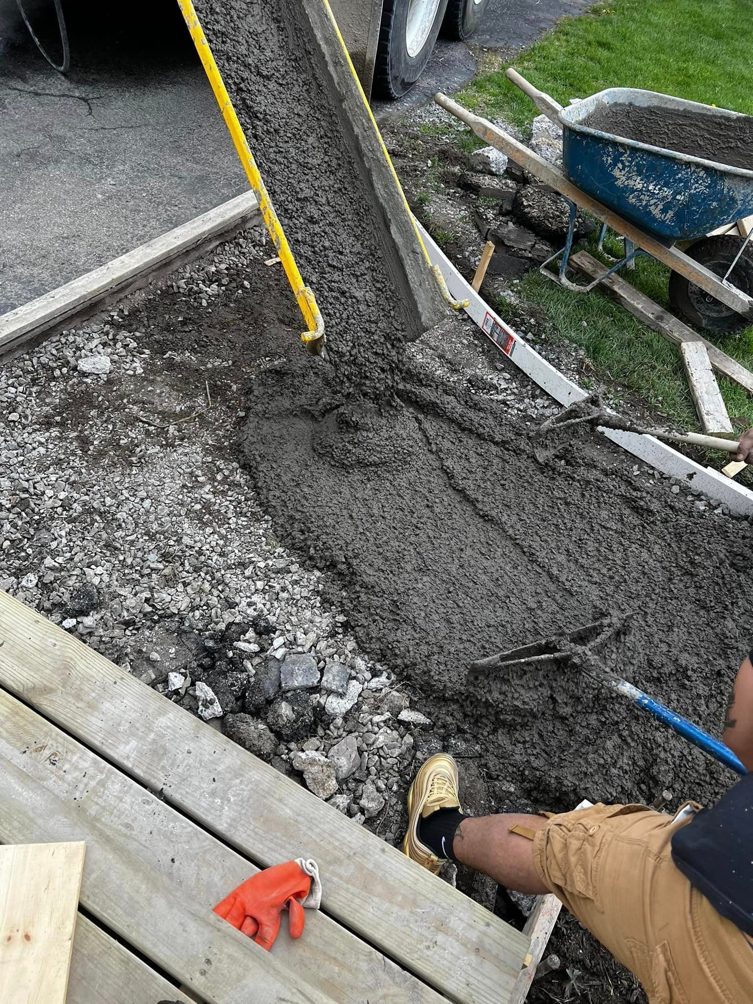 A Person Is Pouring Concrete Cement — Rochester, NY — Monty's Concrete
