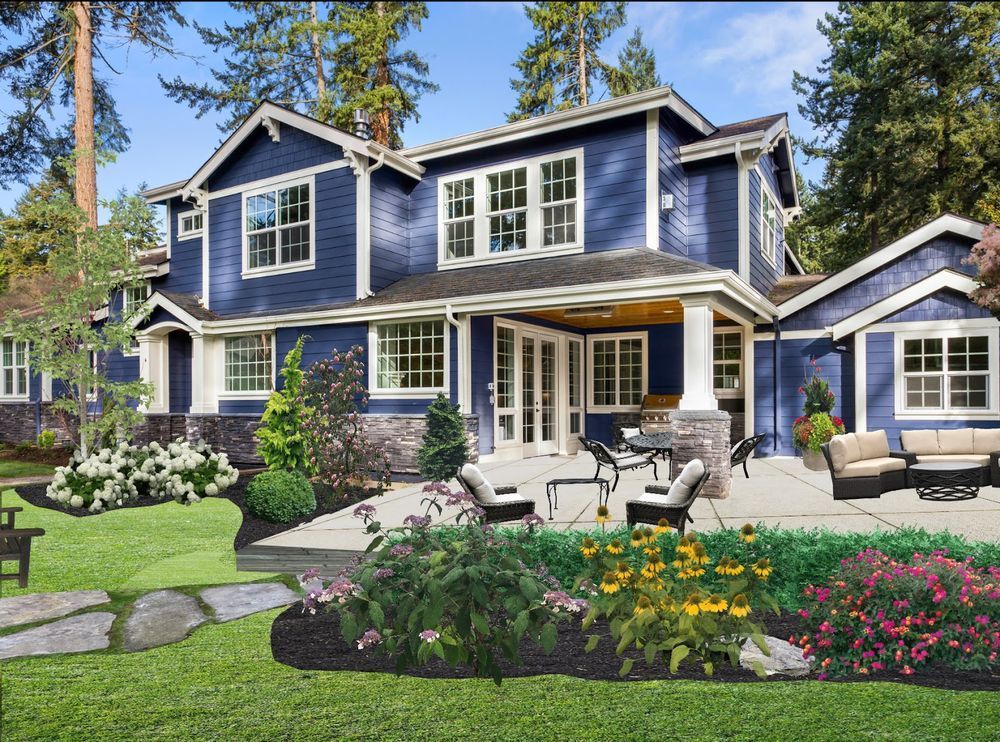 A blue house with white trim and a patio in front of it