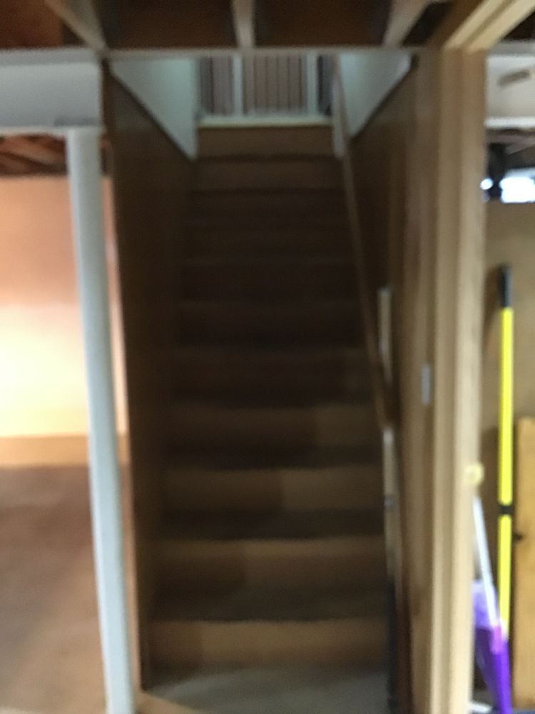 A wooden staircase leading up to the second floor of a house