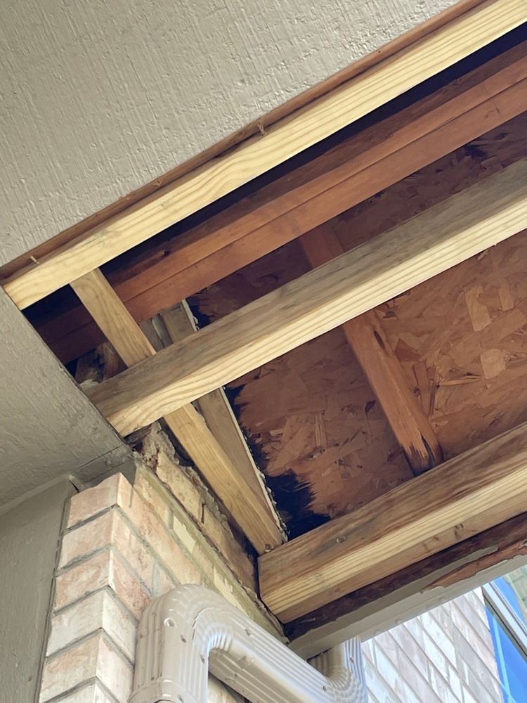 A close up of the ceiling of a building with wooden beams