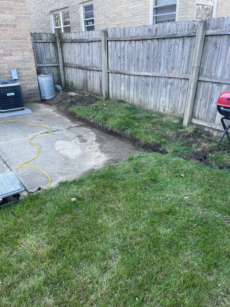 There is a wooden fence in the backyard of a house