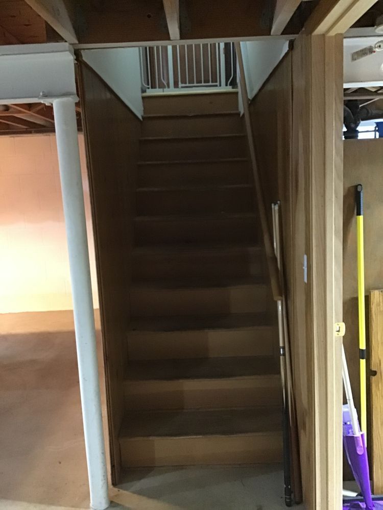 A wooden staircase leading up to the second floor of a house