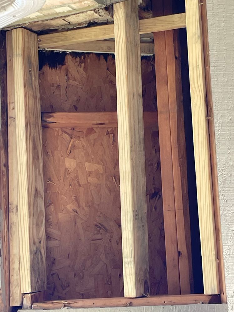 A wooden frame is being built into a wall