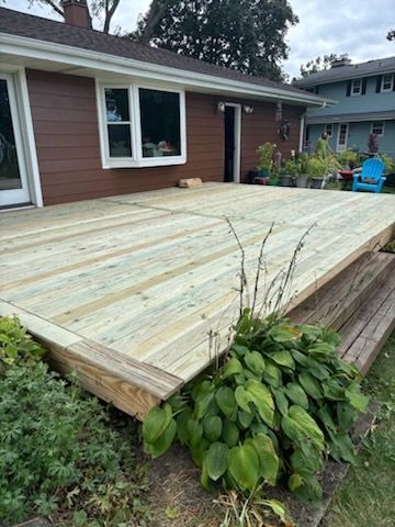 A wooden deck is sitting in front of a house