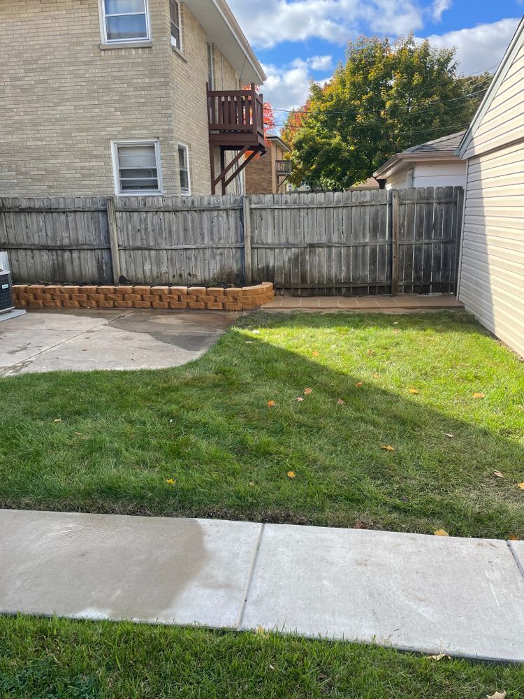 There is a wooden fence in the backyard of a house