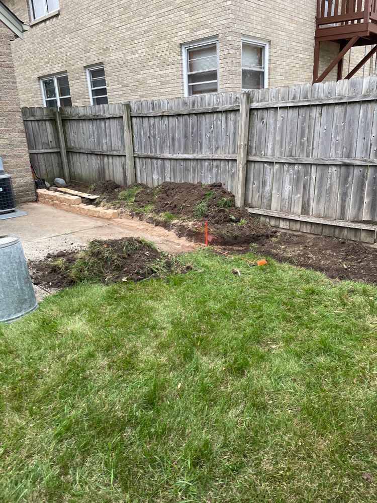 There is a wooden fence in the backyard of a house