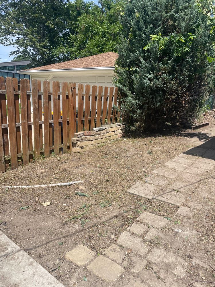 There is a wooden fence in the backyard of a house