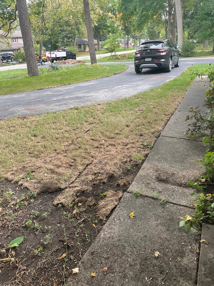 A car is parked on the side of the road next to a sidewalk