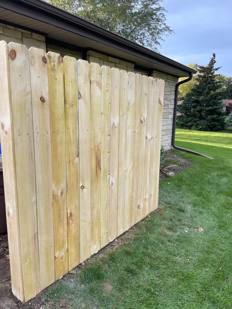A wooden fence is sitting on the side of a house