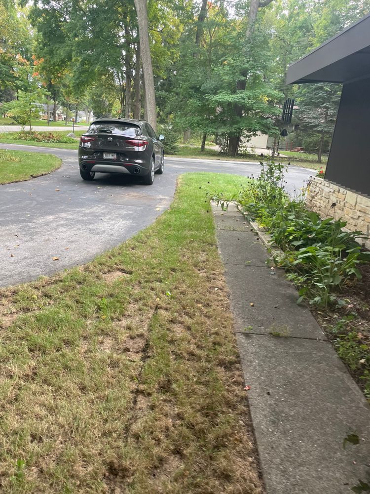 A car is parked on the side of the road next to a sidewalk