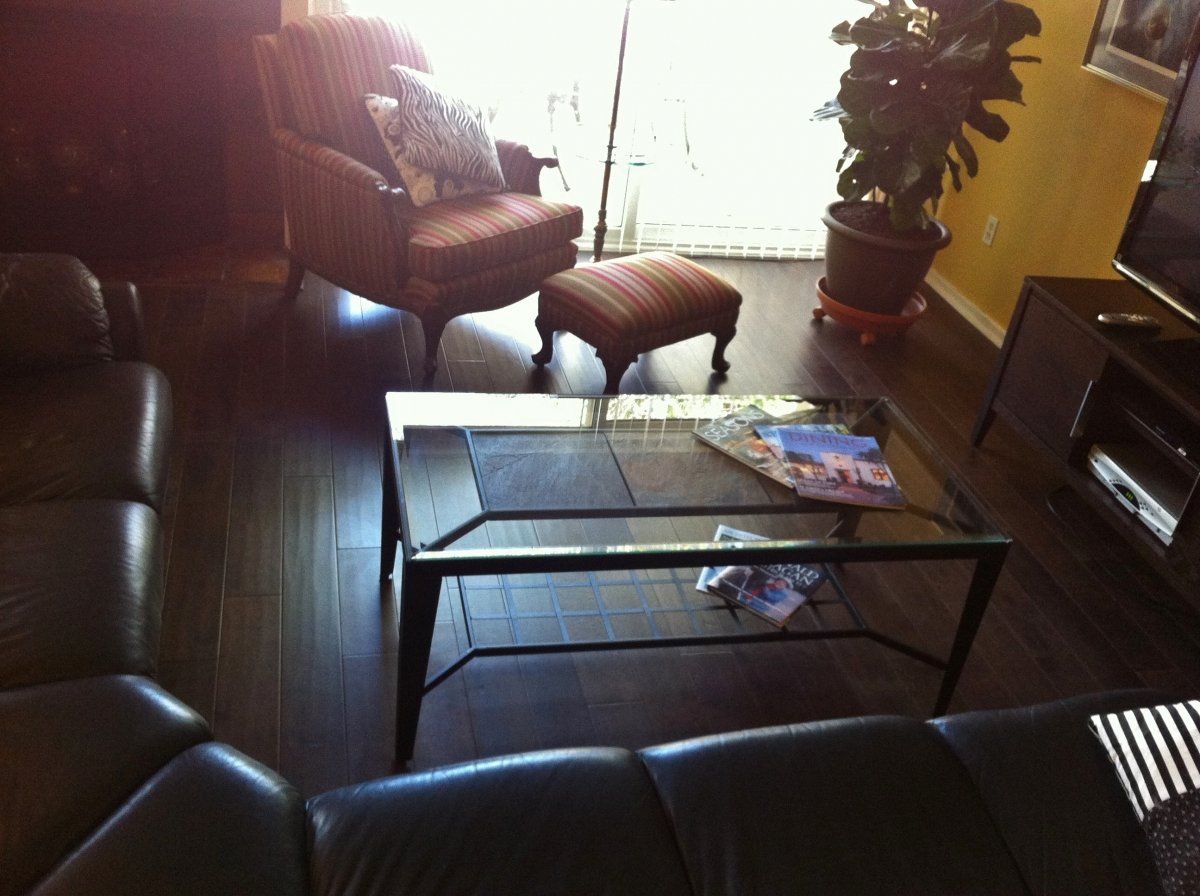 Wood Flooring — Brown Flooring Match With Brown Couch in Stafford, TX