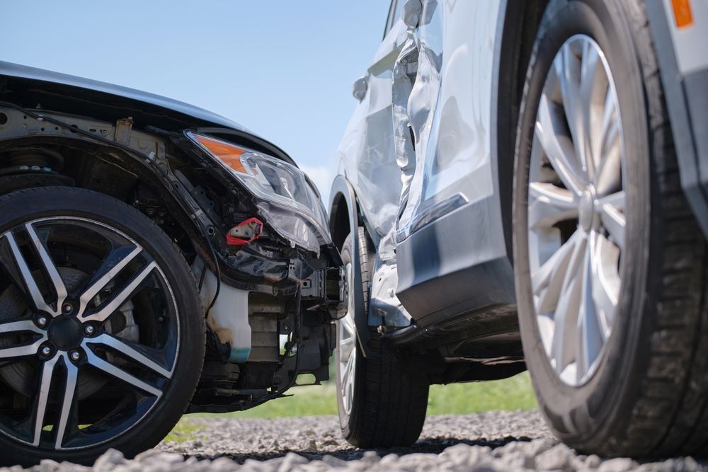 Two Cars Are Parked Next to Each Other on the Side of the Road — Smash Repairs In Wingham, NSW