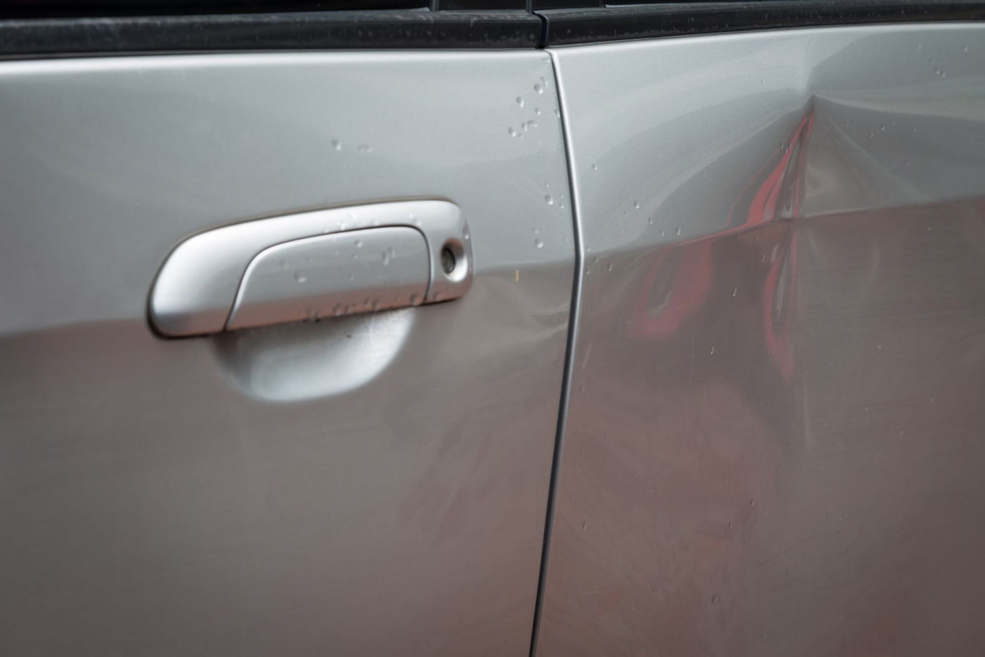 A Close Up of a Car Door Handle on a Silver Car — Smash Repairs In Forster, NSW