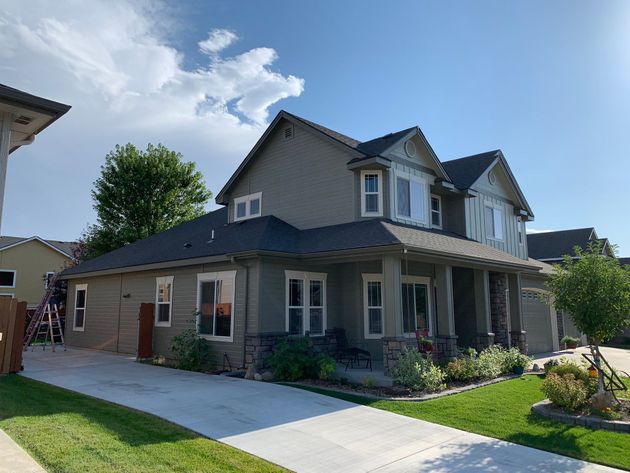 A large house with a lot of windows and a driveway in front of it.