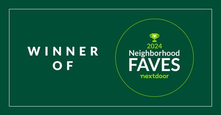 A green sign that says `` winner of neighborhood faves nextdoor ''