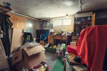 Boxes, junk, and clutter in the basement of a home